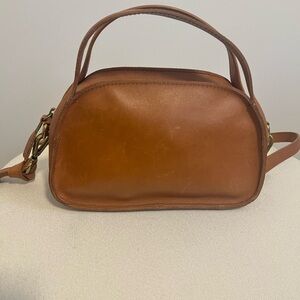 Madewell brown leather mini top handle handbag with crossbody strap.